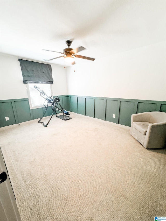 interior space with ceiling fan and carpet flooring