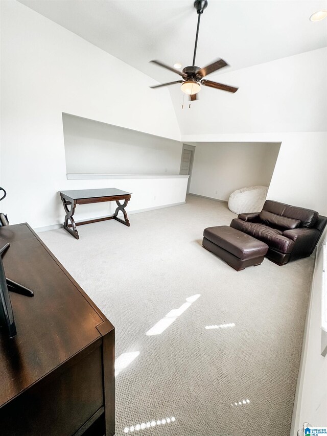 interior space with lofted ceiling, carpet flooring, and ceiling fan