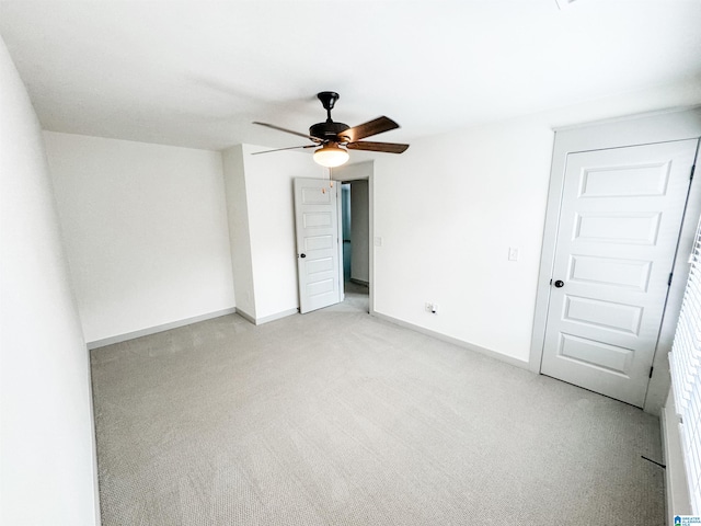 unfurnished room with ceiling fan and light carpet