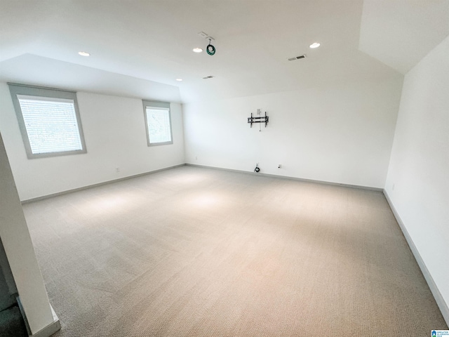 empty room with lofted ceiling and carpet flooring