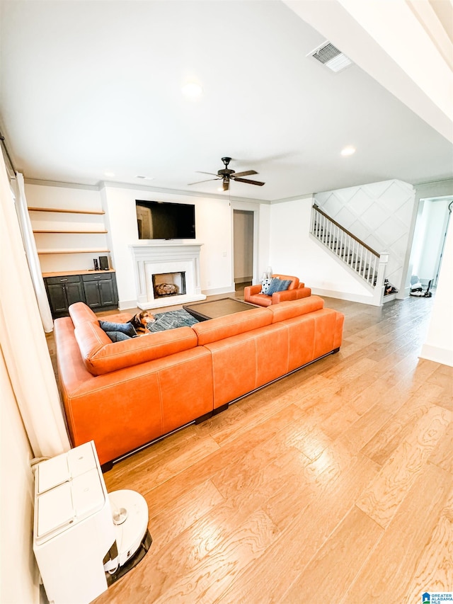 living room with ceiling fan and hardwood / wood-style floors