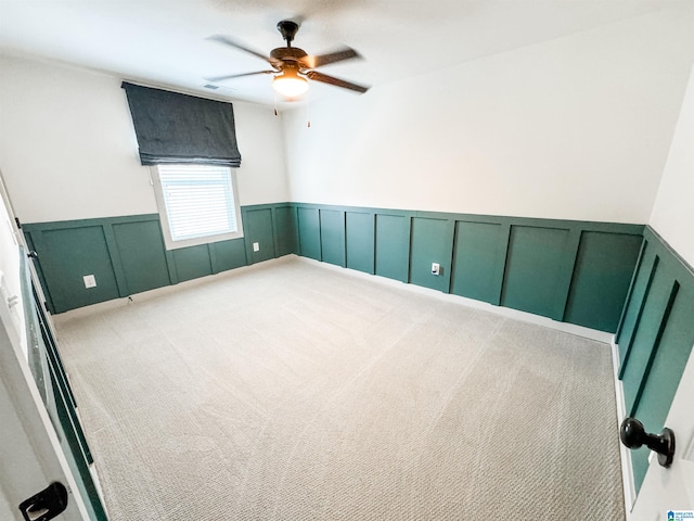 unfurnished room with ceiling fan and carpet flooring