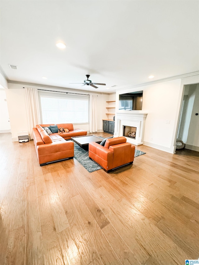 living room featuring ceiling fan and light wood-type flooring