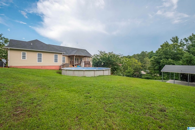 view of yard featuring a carport and a swimming pool side deck