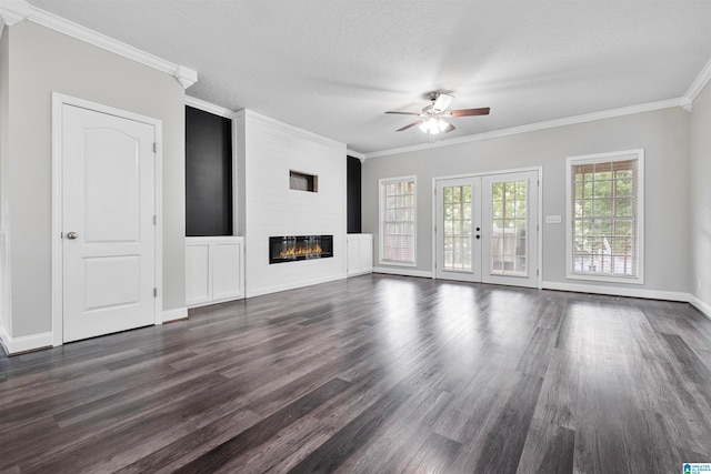 unfurnished living room featuring dark wood-type flooring, crown molding, a fireplace, and ceiling fan