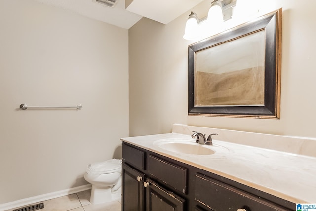 bathroom featuring visible vents, toilet, vanity, baseboards, and tile patterned floors