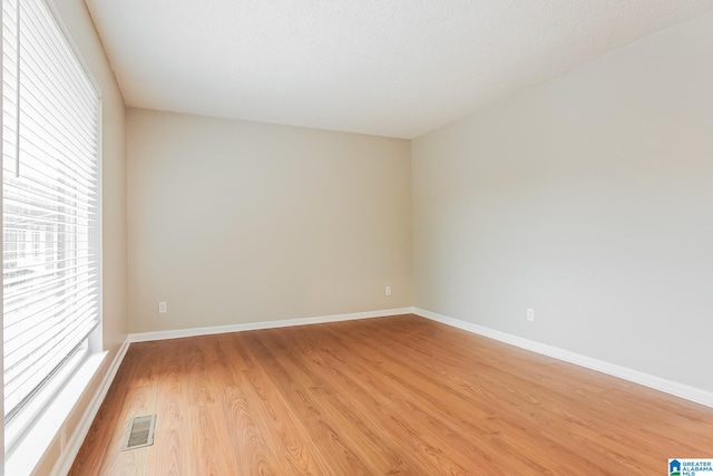 unfurnished room with light hardwood / wood-style floors