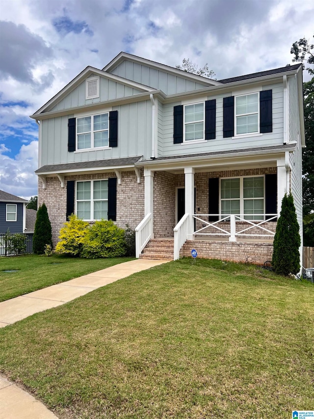 view of front of home with covered porch and a front yard