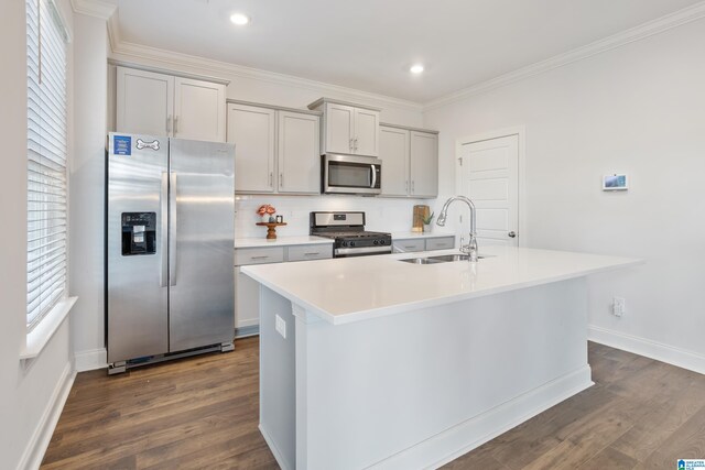 kitchen featuring gray cabinets, sink, a center island with sink, and appliances with stainless steel finishes