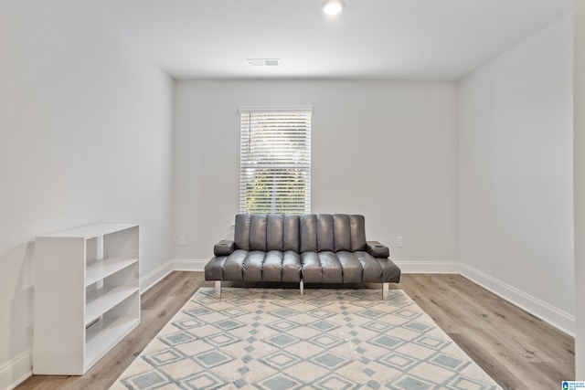 living area with hardwood / wood-style flooring