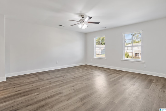 empty room featuring ceiling fan and hardwood / wood-style floors