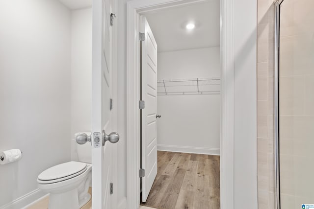 bathroom featuring hardwood / wood-style flooring and toilet