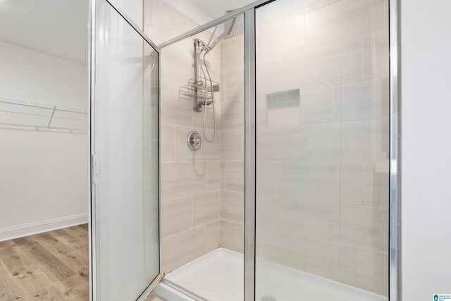 bathroom with wood-type flooring and walk in shower