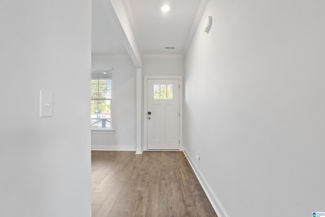 doorway featuring light wood-type flooring and ornamental molding