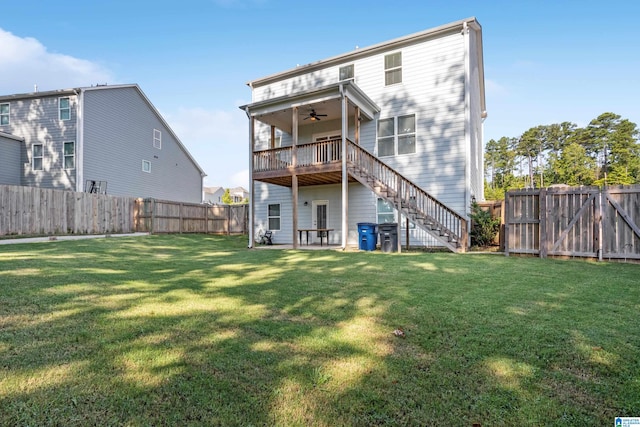 back of property featuring ceiling fan and a lawn