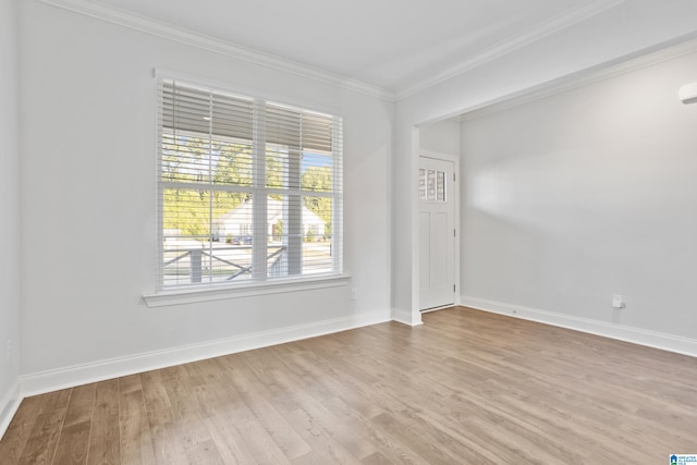 spare room featuring light hardwood / wood-style flooring and ornamental molding