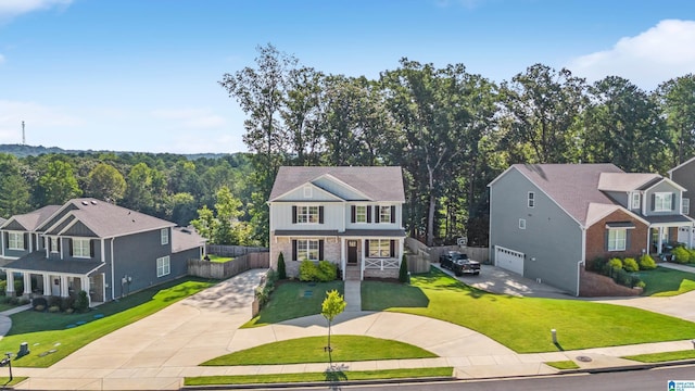 view of front facade with an attached garage, board and batten siding, a residential view, driveway, and a front lawn