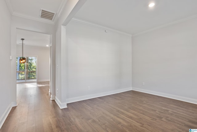 unfurnished room with ornamental molding, visible vents, and dark wood-style floors