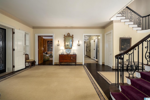 entrance foyer with hardwood / wood-style floors and ornamental molding