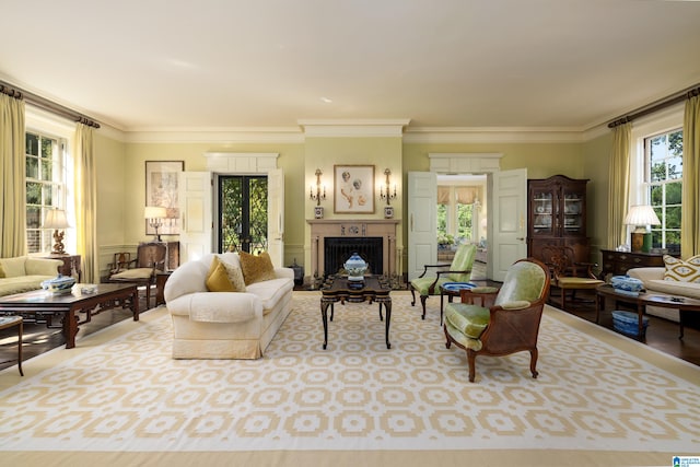 living room featuring french doors, light hardwood / wood-style flooring, ornamental molding, and plenty of natural light