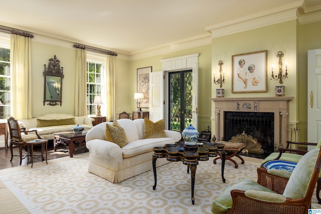 living room with a premium fireplace, ornamental molding, and hardwood / wood-style floors