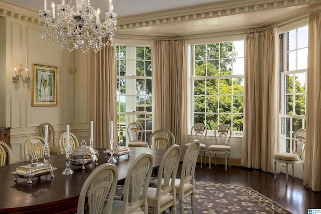 dining room with a notable chandelier, dark hardwood / wood-style flooring, and ornamental molding