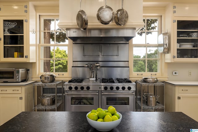 kitchen featuring range with two ovens and white cabinets