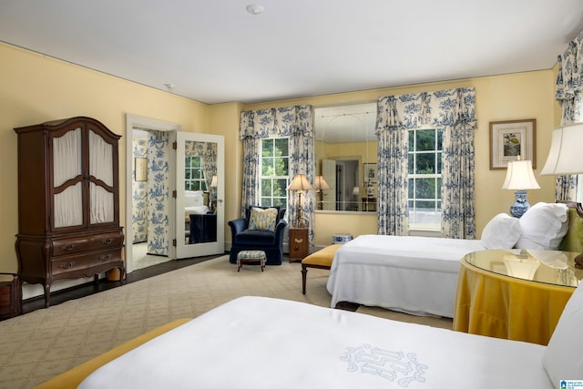 bedroom featuring light colored carpet