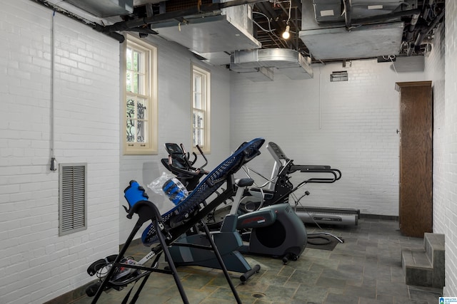 exercise area featuring brick wall