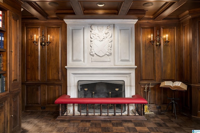 living room featuring wooden walls, ornamental molding, and coffered ceiling