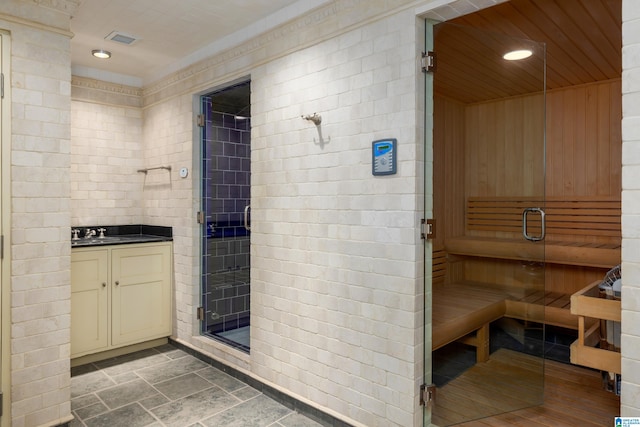 bathroom featuring walk in shower, wood ceiling, brick wall, and vanity