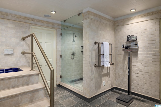 bathroom with a shower with shower door and tile patterned floors