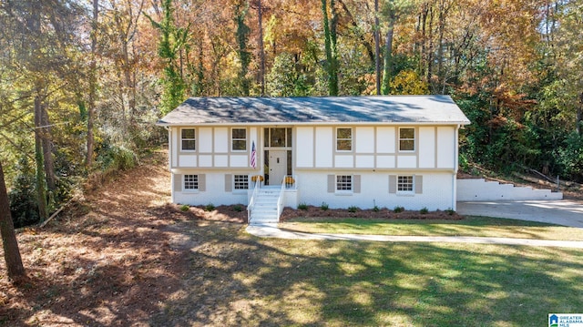 raised ranch featuring a front lawn