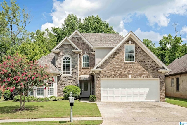 view of front of property featuring a garage and a front lawn