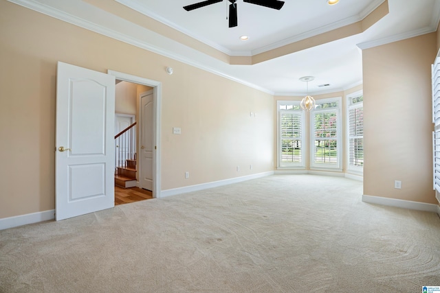 unfurnished room with light carpet, crown molding, a raised ceiling, and ceiling fan