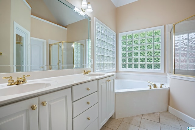 bathroom with tile patterned flooring, separate shower and tub, and double sink vanity