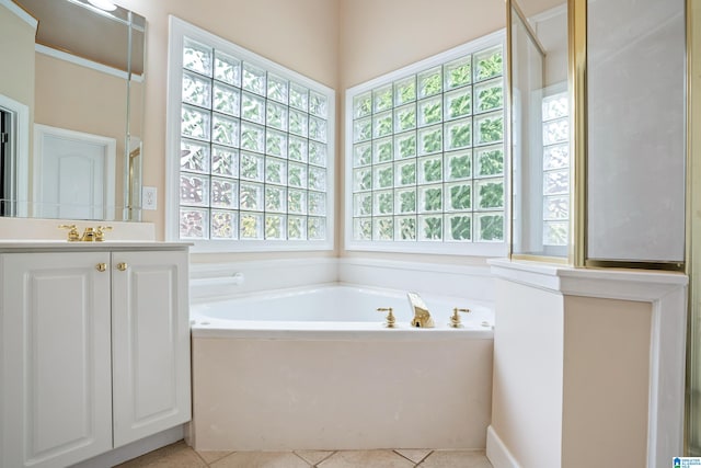 bathroom featuring a washtub, tile patterned floors, and vanity