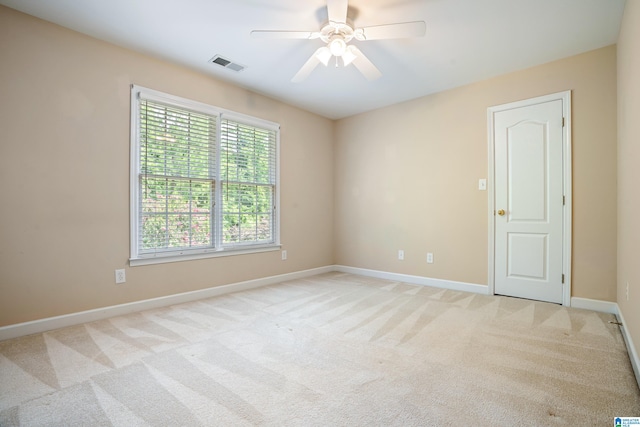 spare room with light carpet and ceiling fan