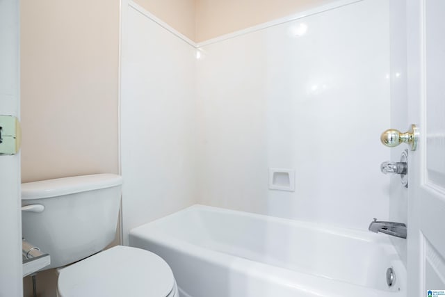 bathroom featuring shower / bathing tub combination and toilet