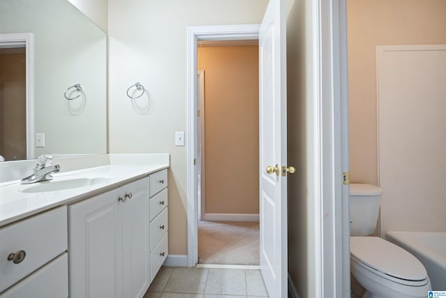 bathroom featuring vanity, tile patterned flooring, and toilet