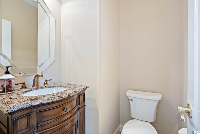 bathroom with toilet and vanity