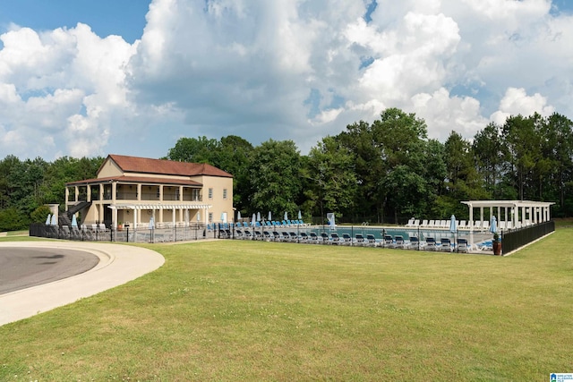 view of community with a swimming pool and a lawn