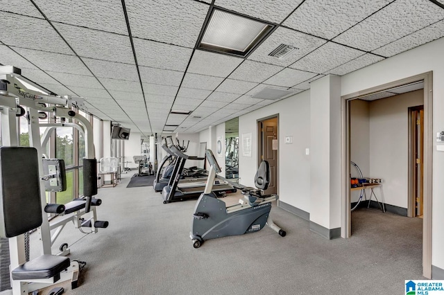 interior space with carpet and a paneled ceiling