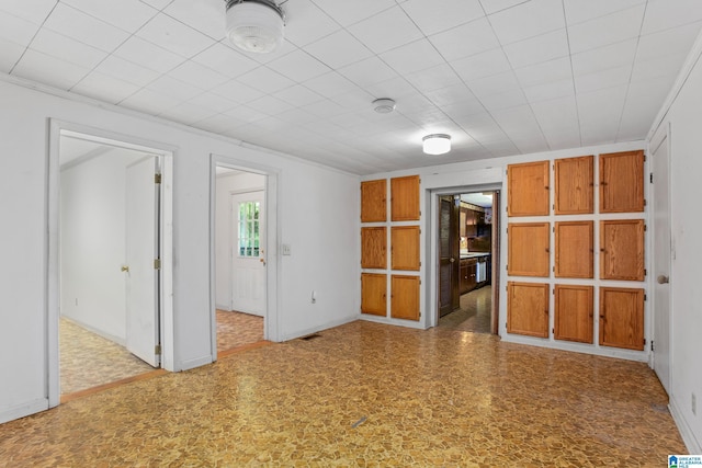 empty room featuring crown molding