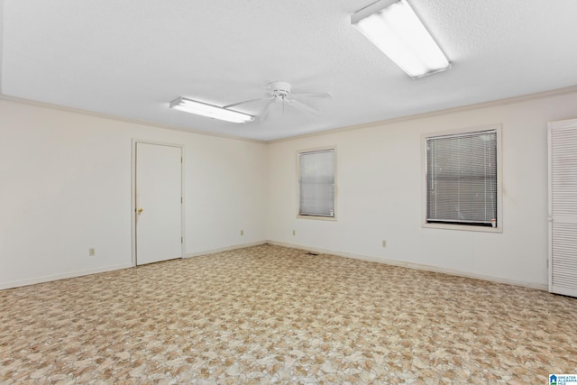 unfurnished room featuring crown molding, ceiling fan, and a textured ceiling