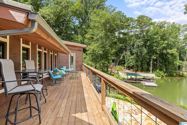 wooden terrace featuring a water view and a boat dock