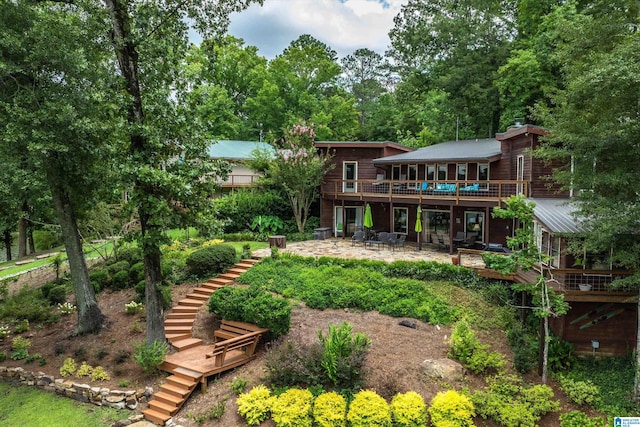 rear view of house with a patio and a deck