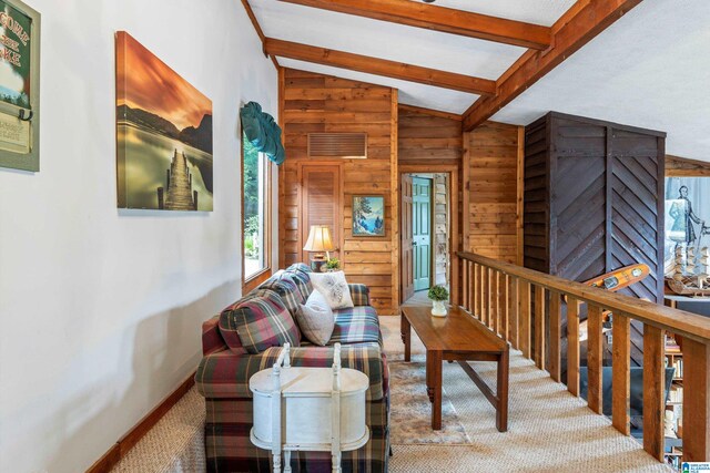 living room featuring carpet flooring, wooden walls, and lofted ceiling with beams