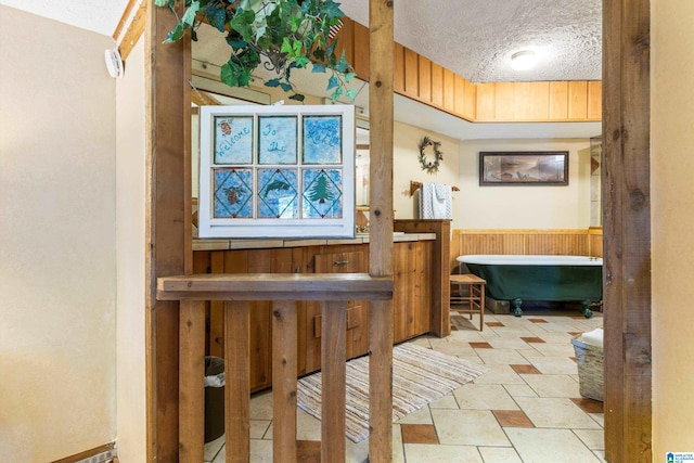 interior space featuring a textured ceiling and tile patterned flooring