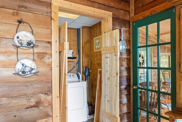 interior space featuring wooden walls and washer / dryer